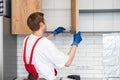 Worker installing new countertop in modern kitchen Royalty Free Stock Photo