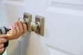 Worker installing a new dummy lock in house on door Royalty Free Stock Photo