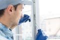 worker installing new plastic pvc window. Royalty Free Stock Photo