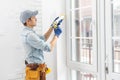 worker installing new plastic pvc window. Royalty Free Stock Photo