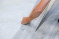 Worker installing new vinyl tile floor laminate wood texture floor with new home improvement Royalty Free Stock Photo