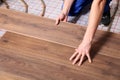 Worker installing new wooden laminate over underfloor heating system, closeup Royalty Free Stock Photo