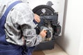 Worker is installing a oil burner Royalty Free Stock Photo