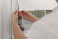 Worker installing roller window blind indoors, closeup Royalty Free Stock Photo