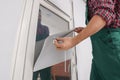 Worker installing roller window blind indoors, closeup Royalty Free Stock Photo