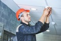 Worker installing smoke detector on the ceiling Royalty Free Stock Photo