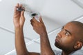 Worker installing smoke detector in room Royalty Free Stock Photo