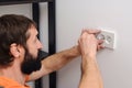 Worker installing socket in new house. Man installing light switch after home renovation Royalty Free Stock Photo