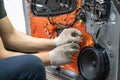 Worker installing special acoustic and vibration-damping material for noise insulation on car door. Soundproofing, auto Royalty Free Stock Photo