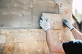 Worker installing stone on architectural facade of new building. details of construction industry Royalty Free Stock Photo