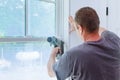 Worker installing trim around a window Royalty Free Stock Photo