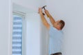 Worker installing trim around a window Royalty Free Stock Photo