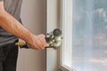 Worker installing trim around a window Royalty Free Stock Photo