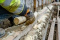 Worker installing wall insulation with woolen material on construction site Royalty Free Stock Photo