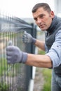 worker installing welded metal mesh fence Royalty Free Stock Photo