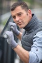 worker installing welded metal mesh fence Royalty Free Stock Photo