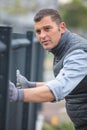 worker installing welded metal mesh fence Royalty Free Stock Photo