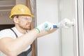Worker in installing white plastic upvc window on house Royalty Free Stock Photo