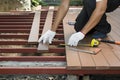Worker installing wood floor for patio Royalty Free Stock Photo