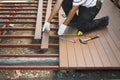 Worker installing wood floor for patio Royalty Free Stock Photo