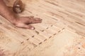 Worker installing wood parquet. Carpenter on work putting wood parquet pieces, Home renovation, Close up Royalty Free Stock Photo