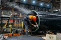 Worker installs clamping ring on coated pipe