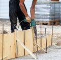 A worker installs formwork on the foundation Royalty Free Stock Photo