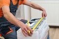 Worker installs indoor unit of the air conditioner. Man preparing to install new air conditioner Royalty Free Stock Photo