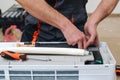 Worker installs indoor unit of the air conditioner. Man preparing to install new air conditioner Royalty Free Stock Photo