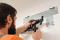 Worker installs indoor unit of the air conditioner. Man preparing to install new air conditioner Royalty Free Stock Photo