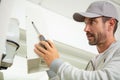 worker installs indoor unit air conditioner on wall Royalty Free Stock Photo
