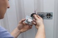 Electrician installs lighting switch Royalty Free Stock Photo