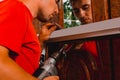 A worker installs new plastic windows in the house, drills holes in the window with a hand-held electric drill Royalty Free Stock Photo