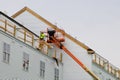 a worker installs panels siding on the facade of the house Royalty Free Stock Photo
