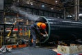 Worker installs pipe connector on coated pipe