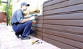 Worker installs plastic siding on the facade Royalty Free Stock Photo