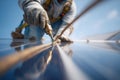 Worker installs solar panel with tools on a rooftop under a clear blue sky during daylight hours Royalty Free Stock Photo