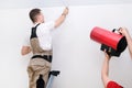 Worker installs a stretch ceiling