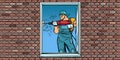 A worker installs a window, drilling a wall