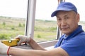 Worker installs windows master checks the level of frame repair in a multi-storey building