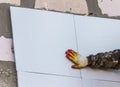 Worker insulates the walls of the house with plastic panels