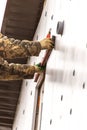 Worker insulates the walls of the house with plastic panels