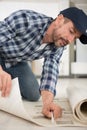 worker insulating floor at construction site