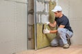 Worker insulating a room wall with mineral rock wool thermal insulation Royalty Free Stock Photo