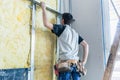 Worker insulating wall of a new building on construction site Royalty Free Stock Photo