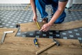 Worker joining vinyl floor covering at home renovation. DIY tools Royalty Free Stock Photo