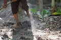 Worker labor feet leveling rocky ground while working with copy space