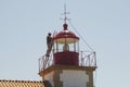 A worker on a ladder, reparing a lighthouse