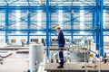 Worker in large metal workshop checking work Royalty Free Stock Photo
