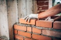 Worker laying bricks on exterior walls Royalty Free Stock Photo